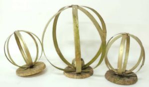 THREE DECORATIVE METAL STRAPPED GARDEN SPHERES, painted gold, largest 68cms (diam.), smallest