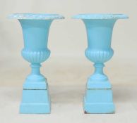 PAIR OF PAINTED CAST IRON PEDESTAL GARDEN URNS, with egg and dart collar, raised on a tapered square