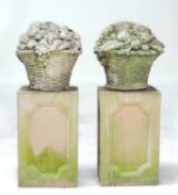 PAIR OF RECONSTITUTED STONE FLOWER BASKETS, nicely weathered and presented on reconstituted stone