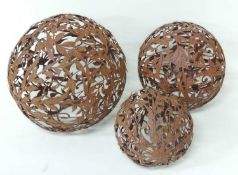 THREE DECORATIVE FRET WORK SHEET METAL GARDEN SPHERES, largest 50cms (diam.) Provenance: The