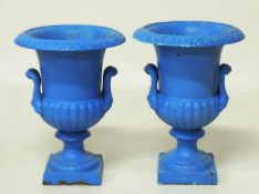 PAIR OF PAINTED CAST IRON CAMPAGNA GARDEN URNS, with twin-handles, over square base, 45 (h) x