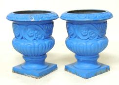 PAIR OF PAINTED CAST IRON GARDEN URNS, squat baluster form, 46 (h) x 39cms (diam.) Provenance: The