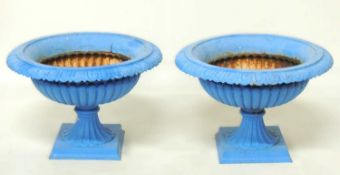 PAIR OF PAINTED CAST IRON SHALLOW URNS with egg and dart collar, over a square base, 40 (h) x