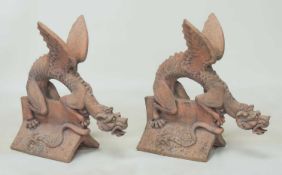 PAIR OF TERRACOTTA RIDGE TILES, each moulded with a dragon, 67 (h), length of tile 38cms, with an