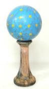 CIRCUS PERFORMANCE INTEREST: PAINTED METAL BALANCING BALL, 48cms (diam.); matched to a terracotta