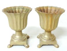 PAIR OF GILT PAINTED CAST IRON SMALL URNS, bellflower form, on square bases with paw feet, 29 (h)
