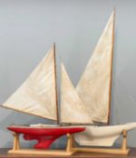 MODEL CLUB HOUSE: TWO VINTAGE SCRATCH BUILT POND YACHTS, one with red hull, the other later