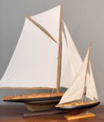 MODEL CLUB HOUSE: TWO MODEL YACHTS, on stands, largest 108 (h) x 111cms (l) (2) Provenance: