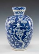 CHINESE BLUE & WHITE VASE, of ovoid form, painted with flowering prunus and gnarled branches, base