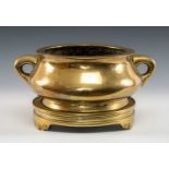 LARGE CHINESE BRONZE CENSER ON STAND, Qing Dynasty, bombé form with twin loop handles, on tripod