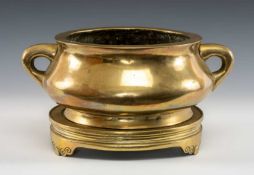 LARGE CHINESE BRONZE CENSER ON STAND, Qing Dynasty, bombé form with twin loop handles, on tripod