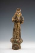 SPANISH COLONIAL CARVED WOOD SANTO, probably Philippines, dressed in monk's habit, on plinth base,