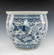 LARGE CHINESE BLUE & WHITE PORCELAIN JARDINIÈRE, painted with four-clawed dragon amongst flowering