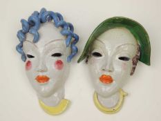 TWO GOLDSCHEIDER STYLE ART DECO WALL MASKS, one wearing green hat, the other with blue curly hair,
