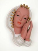 GOLDSCHEIDER ART DECO WALL MASK of a woman resting her face on her hands, mottled cream and gold