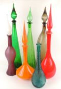NUMBER OF COLOURED GLASS BOTTLES, all with stoppers, with the exception of a knobbly moulded glass