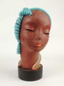 GOLDSCHEIDER ART DECO BUST of a stylised lady, turquoise and orange glaze, on ebonised wood drum