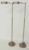 PAIR OF BRASS ADJUSTABLE READING STANDARD LAMPS, on weighted circular bases, height is adjustable,