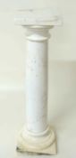 WHITE MARBLE IONIC COLUMN STAND, 94cms (h), top 25.5cms Provenance: The collection of Philip