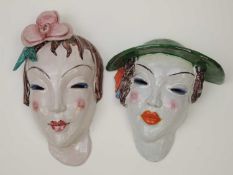 TWO GOLDSCHEIDER STYLE ART DECO WALL MASKS of ladies, one wearing green hat, the other with pink