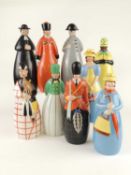 ROBJ PORCELAIN, PARIS: NINE LIQUEUR DECANTERS, modelled as characters in traditional dress, 28cms (