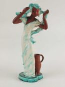 GOLDSCHEIDER ART DECO FIGURE of a lady standing by a ewer, turquoise and cream glaze, black