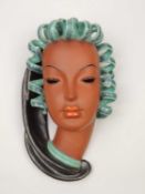 GOLDSCHEIDER WALL MASK, Prischel, in turquoise and metallic black glazes, impressed marks, 29cms (h)