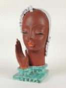GOLDSCHEIDER ART DECO BUST of a stylised lady with raised hand, cream and green glaze, black printed