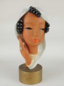 GOLDSCHEIDER ART DECO FACE MASK of a stylised lady, on giltwood drum base, black printed backstamp
