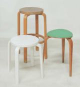 TWO VINTAGE BENT WOOD STACKING STOOLS, originally designed by Alvar Aalto, 68 and 45cms (h);