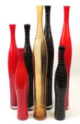 NUMBER OF RUBY & BLACK GLASS SLENDER BOTTLE VASES, three of which are incised with horizontal bands,