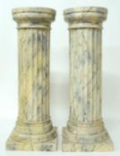 PAIR OF FAUX MARBLE COLUMNS in painted cast plaster, 93cms (h), tops 31cms (diam.) Provenance: The