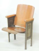 VINTAGE CAST IRON & BENT PLYWOOD THEATRE SEAT, c. 1920, side panels cast with an Aladdin lamp,