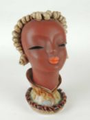 GOLDSCHEIDER ART DECO BUST of a stylised lady, beige and green glaze, with maker's label to neck,