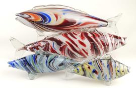 FOUR COLOURED GLASS FISH, largest 55cms, smallest 29cms (4) Provenance: The collection of Philip