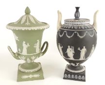 WEDGWOOD BLACK JASPERWARE LIDDED URN, decorated with a band of Grecian musicians and actors, on a