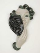 GOLDSCHEIDER ART DECO WALL MASK, green, cream, and black glaze, impressed marks to reverse, 35cms (