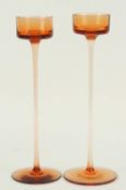 TWO WEDGWOOD BRANCASTER ORANGE GLASS CANDLESTICKS, designed by Ronald Stennett Wilson, one stick
