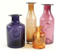 FOUR DARTINGTON COLOURED GLASS BOTTLES, largest 27.5cms (h), smallest 13.5cms (h) (4) Provenance: