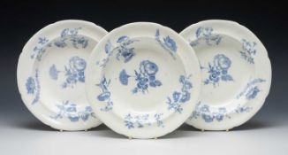 SWANSEA PORCELAIN TRIO OF SOUP PLATES, with under-glazed blue flower decoration, unmarked, 25cms (
