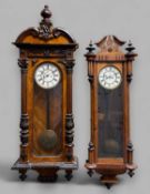 TWO VIENNA-TYPE WALNUT WALL CLOCKS, larger with stained door pilasters and foliate detailing, two-