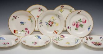 NINE SIMILAR SWANSEA PORCELAIN PLATES, enamelled flower decoration within solid gilt rim, one