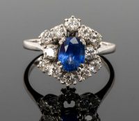 SAPPHIRE & DIAMOND CLUSTER RING, oval-cut sapphire approx. 0.75cts, set within a constellation of