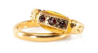 TWO 18CT GOLD RINGS, one Victorian and mounted with three small garnets, and the other a wedding