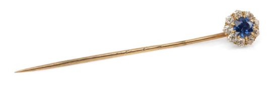 ANTIQUE YELLOW METAL SAPPHIRE & DIAMOND CLUSTER PIN, the claw-set round-cut sapphire within border