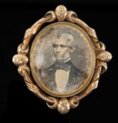 YELLOW METAL MEMORIAL BROOCH, with swivel daguerreotype/ambrotype photographs of gentlemen, ribbon