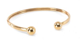 9CT GOLD PENANNULAR BANGLE with spherical terminals, 5.6g Provenance: private collection Merthyr