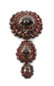VICTORIAN GARNET CLUSTER PENDANT BROOCH, largest cabochon stone (cracked), all backed with silver