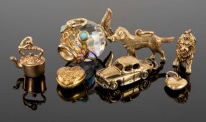 SIX ASSORTED 9CT GOLD CHARMS, 14.8g; together with a 9ct gold-mounted cut-crystal fish charm, 25mms,