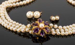 CULTURED PEARL THREE-STRAND CHOKER NECKLACE, largest pearls 7mms (diam.), united by an amethyst
